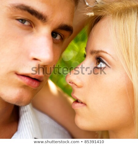 Foto stock: Portrait Of Beautiful Young Couple Standing Against Green Tree I