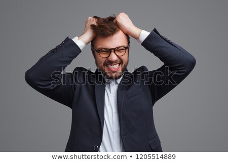 Stockfoto: Frustrated Young Businessman Pulling His Hair Studio Shot