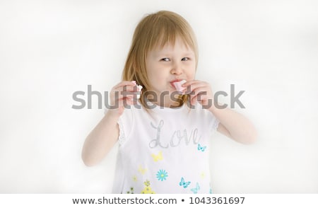 [[stock_photo]]: Smiling Girl Eating Marshmallows