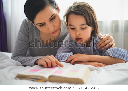 [[stock_photo]]: Young Family Reading The Bible