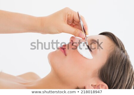 [[stock_photo]]: Close Up Side View Of Hand Plucking Eyelashes