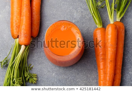 Stock fotó: Carrot Juice In Glass And Fresh Carrots Healthy Food On A Grey Stone Background Top View