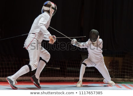 Stok fotoğraf: Athlete In Fencing Uniform With Sword