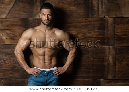 Stockfoto: Young Man Exercising Triceps In Healthy Club