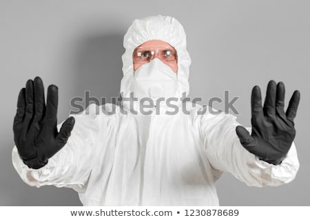 Stock photo: Medical Scientist In Protective Clothing Gesturing Stop Sign In