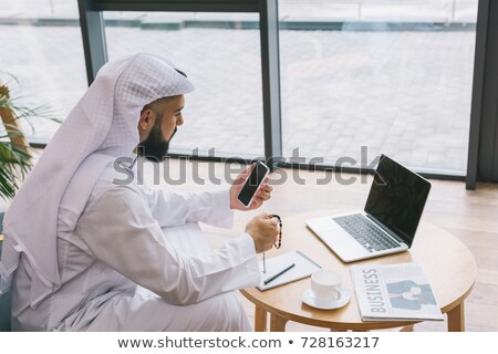 ストックフォト: A Middle Eastern Businessman Sitting With A Laptop