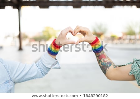 Сток-фото: Couple With Gay Pride Rainbow Wristbands And Heart