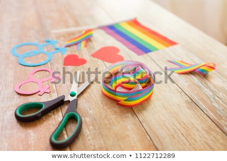 Foto stock: Scissors And Gay Party Props On Wooden Table