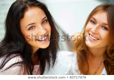 Zdjęcia stock: Two Women Whispering And Smiling While Shopping Inside Mall