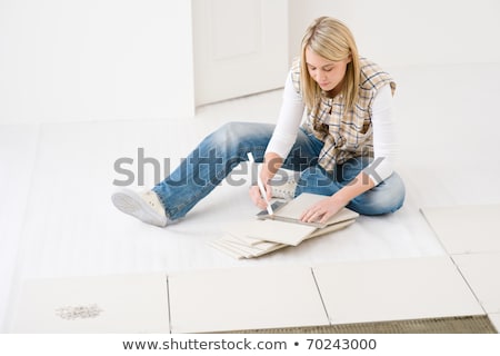 Foto stock: Woman Cutting Tiles