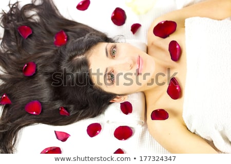 [[stock_photo]]: Rose Petals Surround A Woman Laying On A Bed