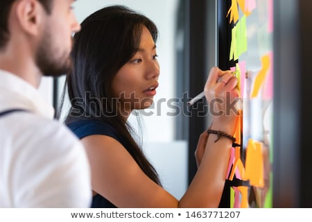 Zdjęcia stock: Girl Writing On A Glass Wall