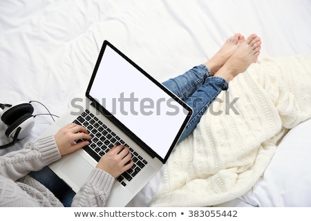 ストックフォト: Woman Using Laptop On Her Bed