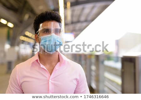 Stock photo: Businessman At The Sky Train Station In Bangkok Thailand