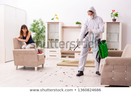 Foto stock: Young Professional Contractor Doing Pest Control At Flat