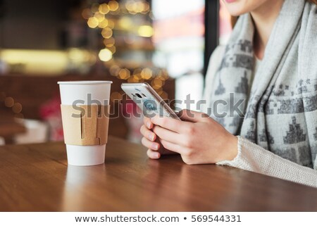 Stok fotoğraf: Young Woman With A Mobile Phone In The Diner