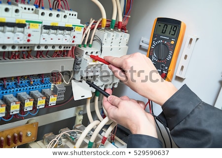 Stok fotoğraf: Electrician Testing The Current With A Multimeter