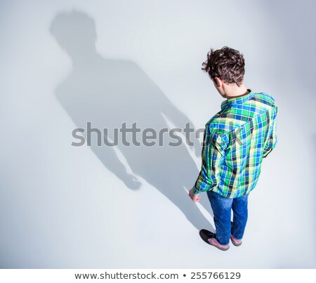 Stock fotó: Top View Portrait Of A Young Man In Colourful Wear Standing Over Gray Backgorund