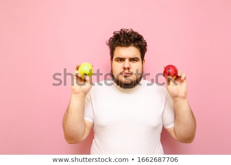 Stok fotoğraf: Man Standing On Scale And Holding Apple In Hand