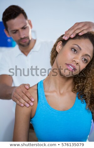 [[stock_photo]]: Physiotherapist Giving Neck Massage To Girl Patient In Clinic