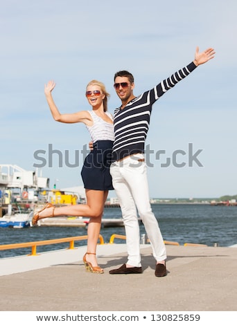 ストックフォト: Couple In Sunglasses Hugging And Waving Hands