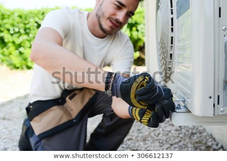 Stock fotó: An Electrician Men Checking Air Conditioning Unit
