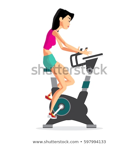 Foto d'archivio: Beautiful Young Lady Riding The Bicycle In A Gym