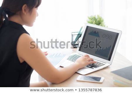 [[stock_photo]]: Business Woman Working On Laptop With Financial Report Concept