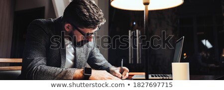 Stok fotoğraf: Creative Man With Smartwatch At Night Office