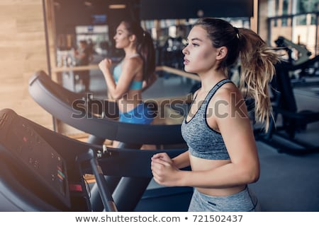 Foto d'archivio: Side View Of A Woman On Treadmill