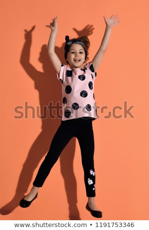 Stock fotó: A Cute Girl 5 Year Old Posing In Studio Pointing