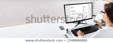 Stockfoto: Woman Using The Computer With Invoice Form On Screen