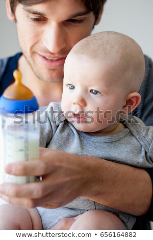 Stock photo: Father Offering Baby Bottle