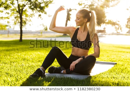 ストックフォト: Blonde Sports Woman In Park Outdoors Showing Biceps