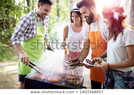 [[stock_photo]]: Friends Enjoying Barbecue In Garden