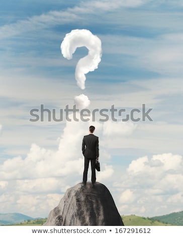 [[stock_photo]]: Businessman On Rock Mountain With A Question Mark