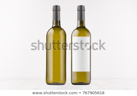 ストックフォト: Green Wine Bottle With White Wine On White Wooden Board Mock Up Vertical