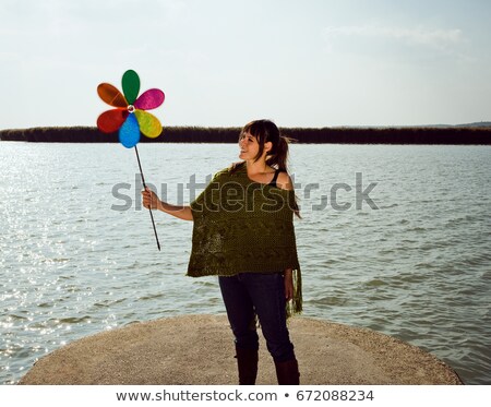 Stock photo: Girl Holding Toy Windmill By Lake