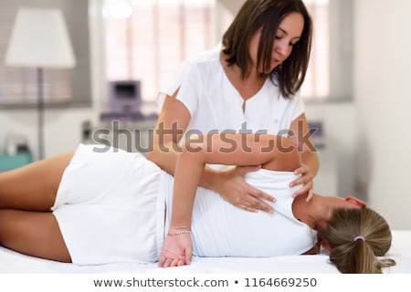 Stok fotoğraf: Therapist Giving Shoulder Massage To Female Patient