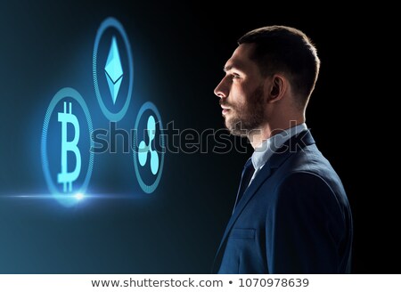 Stock fotó: Buisnessman Looking At Cryptocurrency Icons