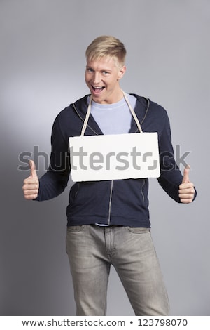Stock fotó: Joyful Man Giving Thumbs Up At Empty Signboard