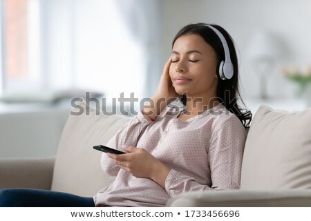 [[stock_photo]]: People And Technology Concept Satisfied Female Meloman Enjoys Favourite Music Listens Audio Record