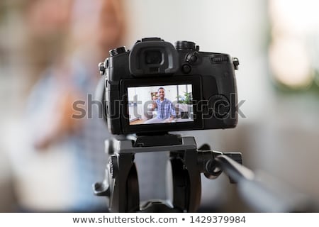 Foto stock: Male Blogger With Camera Videoblogging At Home