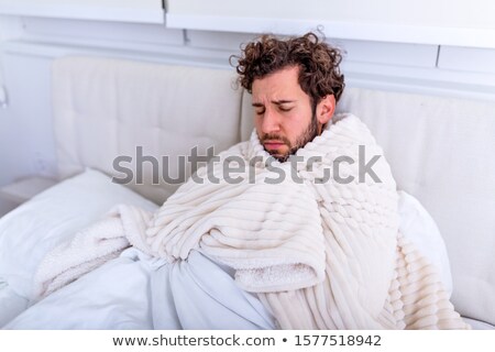 Stok fotoğraf: Closeup Portrait Of Young Man Sitting On Sofa With Headache