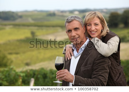 Foto stock: Couple With Wine Glass In Front Of Vineyard