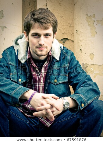 Zdjęcia stock: Young Man Wearing Only Jeans And Sitting