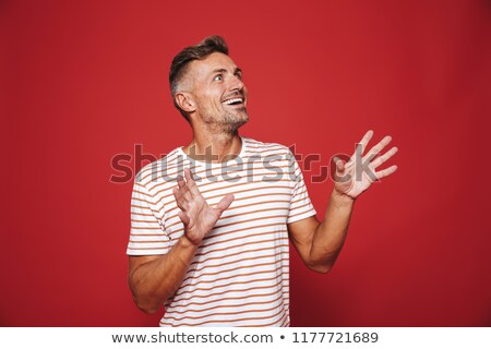 ストックフォト: Brunette Man In Striped T Shirt Rejoicing And Looking Aside At C