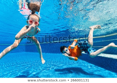 [[stock_photo]]: Kids Having Fun Playing Underwater In Swimming Pool On Summer Vacation