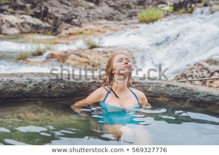 Foto stock: Geothermal Spa Woman Relaxing In Hot Spring Pool Against The Background Of A Waterfall