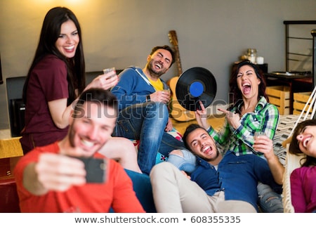 Stockfoto: Happy Friends With Smartphone At Home Party